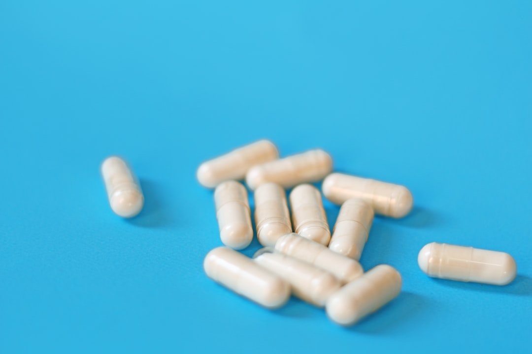 A pile of white pills on a blue background