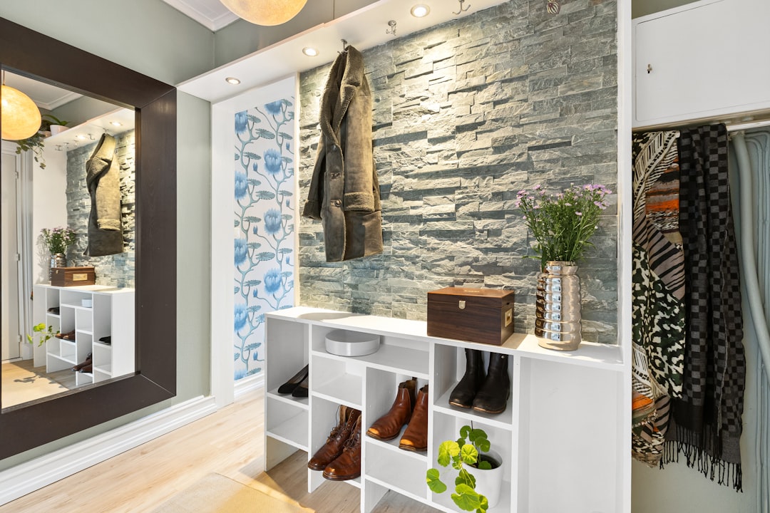A room with a mirror and a shelf with shoes on it
