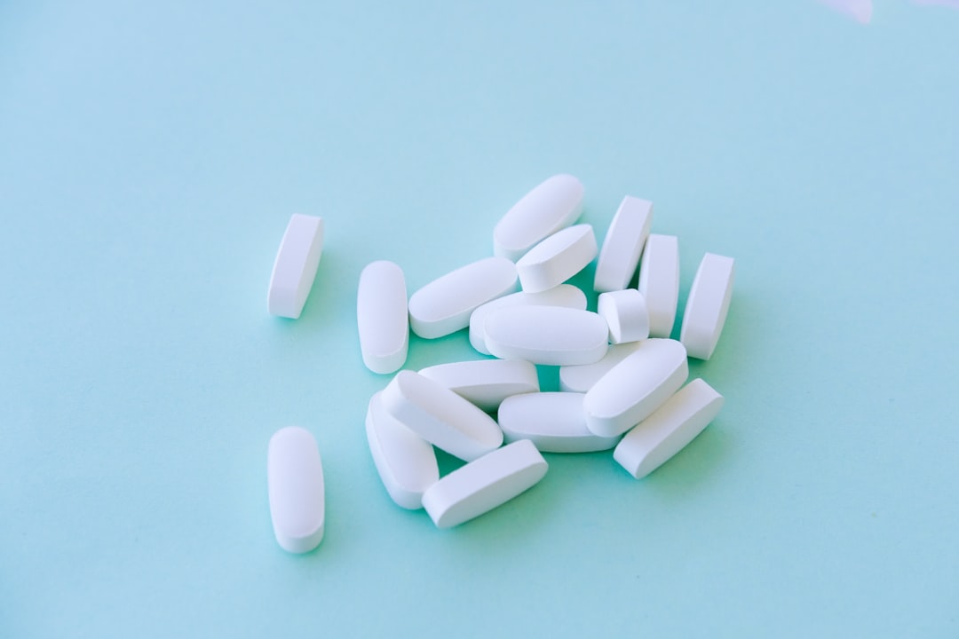 A pile of pills sitting on top of a blue table